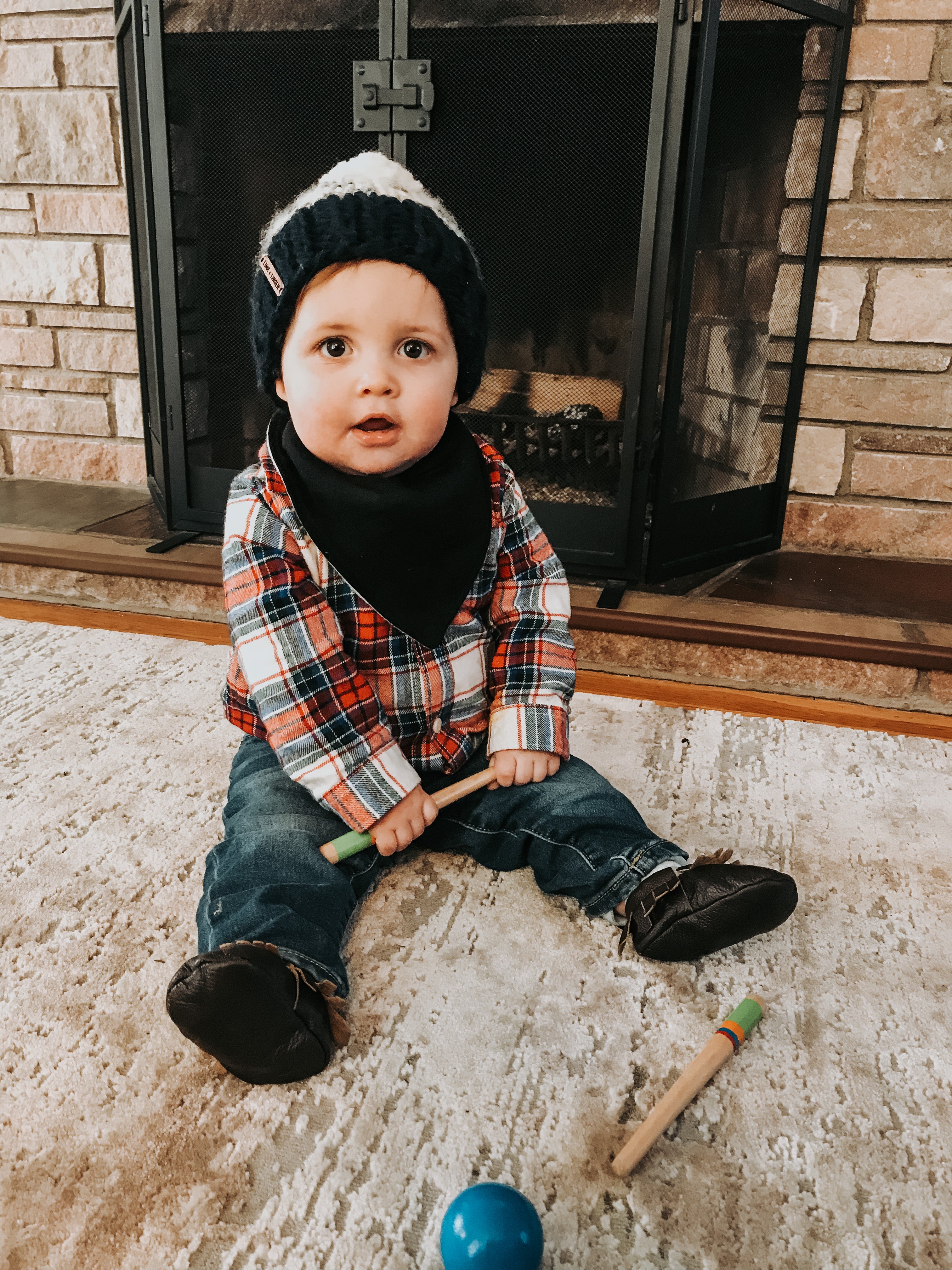 baby wearing knit hat and flannel